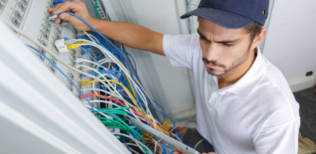 portrait of electrician wiring electrical panel